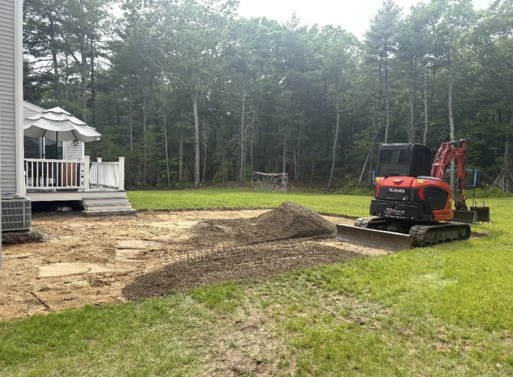 Compact excavator preparing a residential slab base