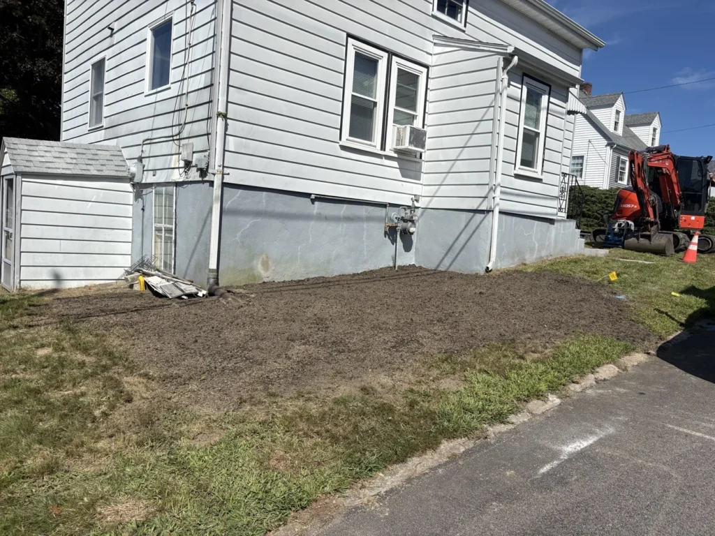 Backfilled and graded ground following utility excavation