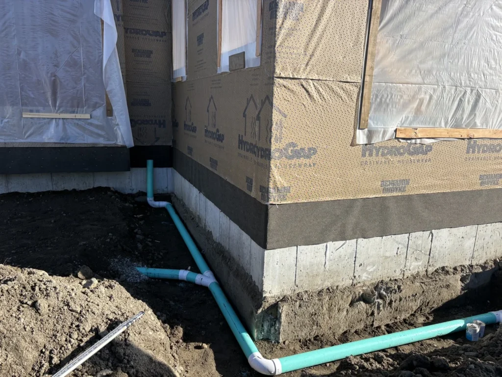 Underground piping beside a building foundation
