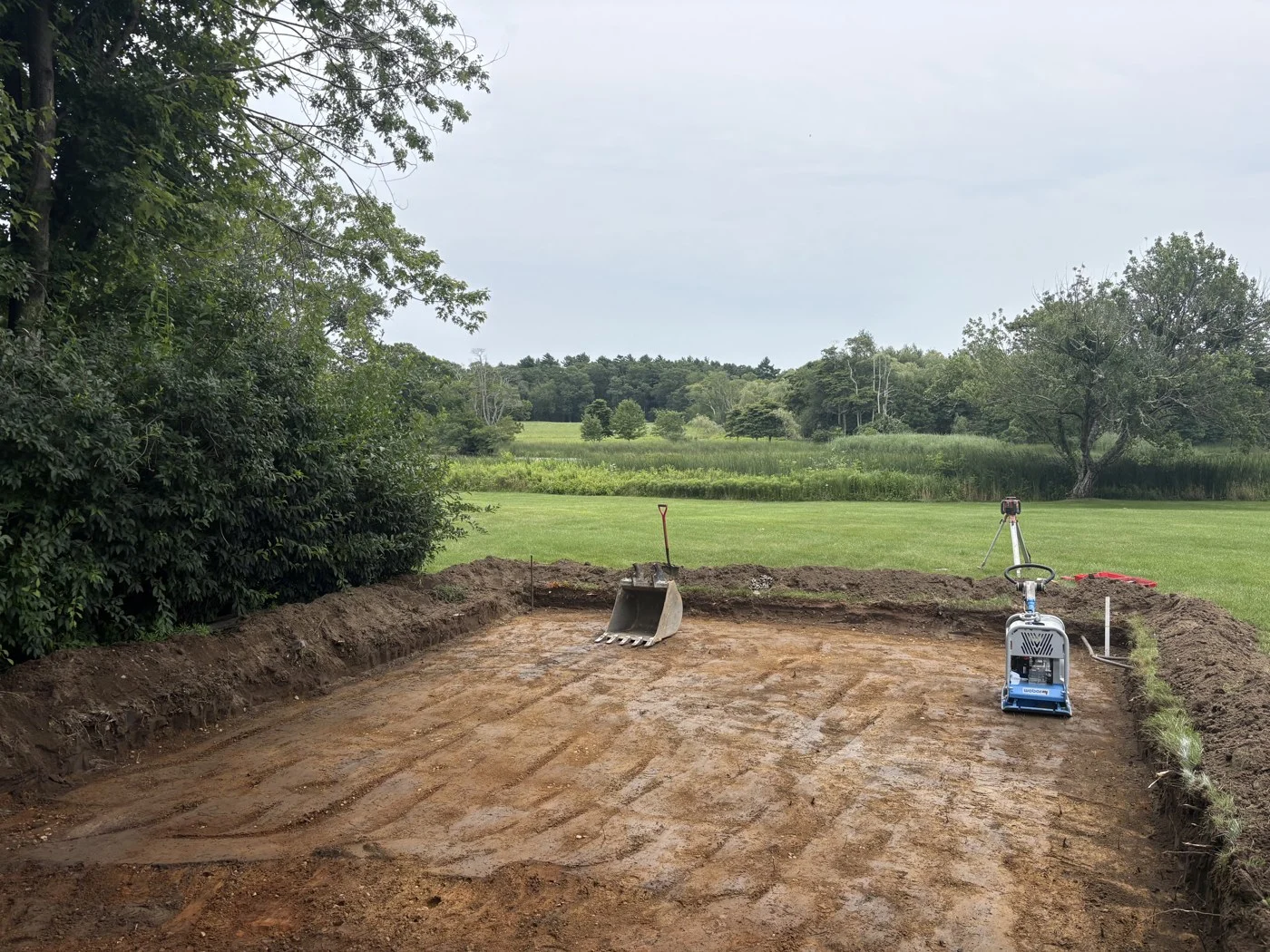 Excavation in progress for a prepared aggregate pad