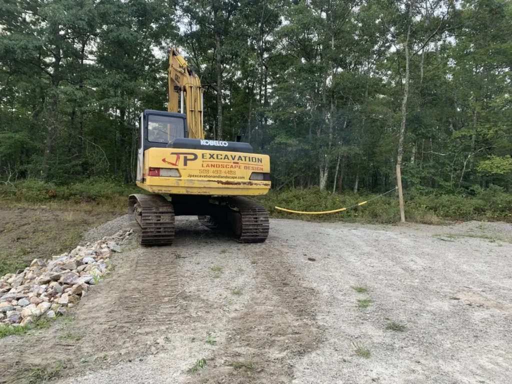 JP Excavation Volvo excavator beside a gravel access road